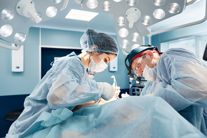 Image of surgeons operating on a patient as the featured image for "Is Reconstructive Surgery Necessary After Mohs Surgery?"